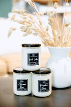 Load image into Gallery viewer, three scented soy candles stacked near fall home decor in a white vase, jar candle, black and white, soy wax, black lid, handmade soy wax candle, light my candle co., pumpkin spice, fall decor

