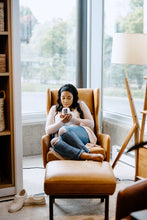 Load image into Gallery viewer, woman sitting in a brown leather chair smelling a scented soy candle
